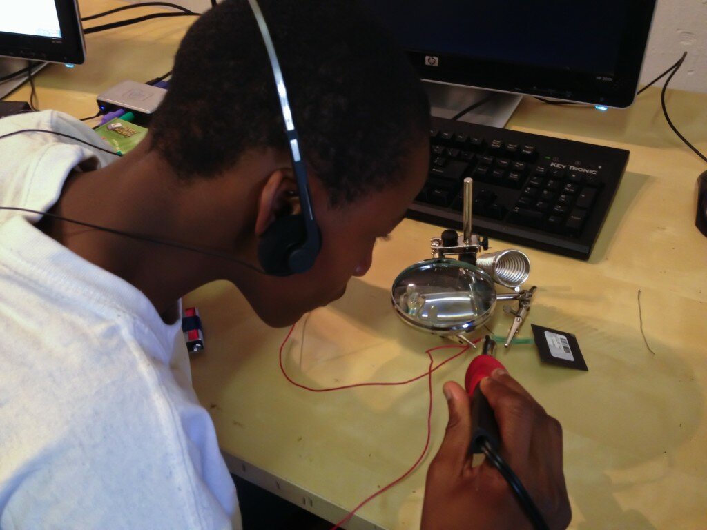 Kevin learning how to solder and desolder.
